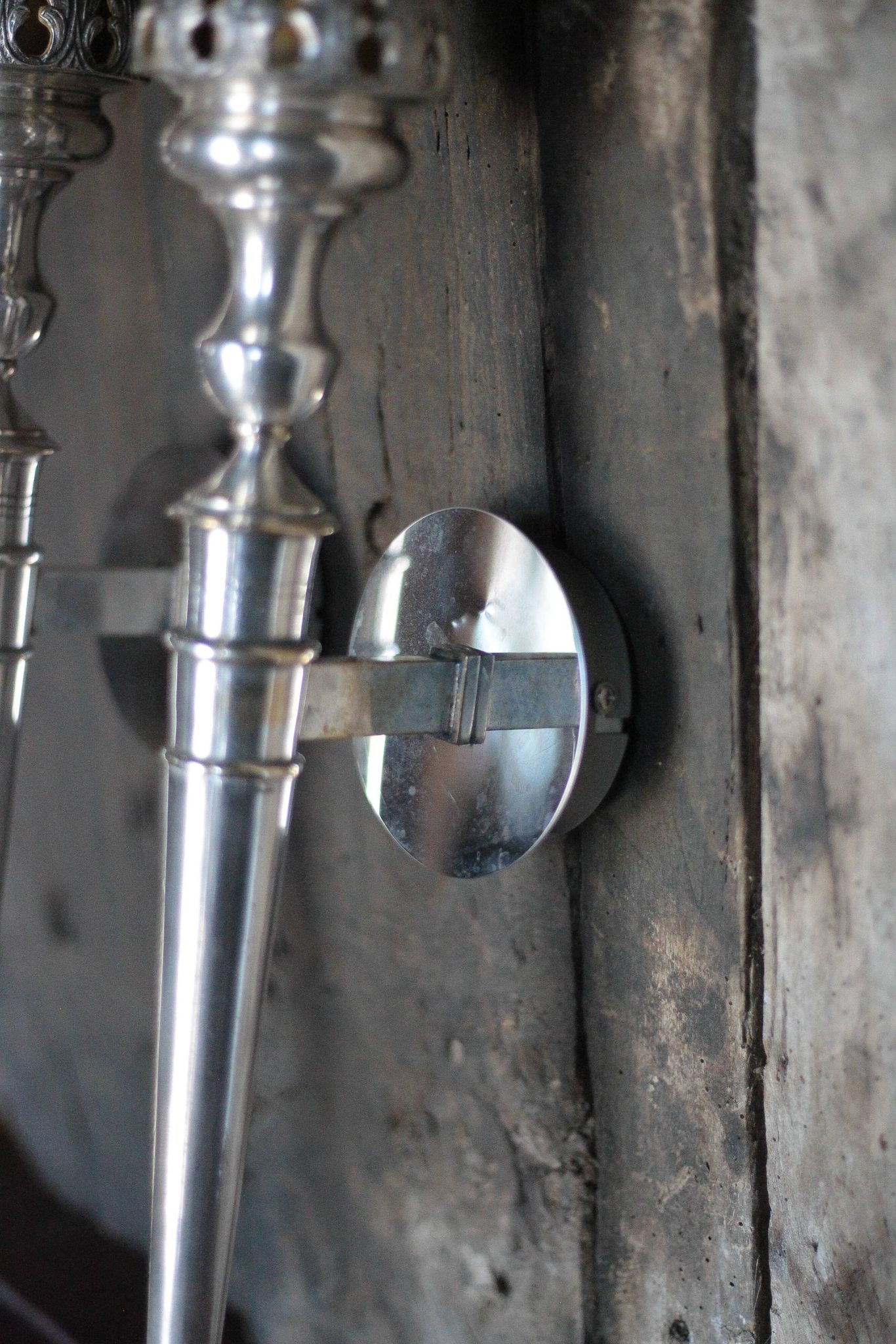 Large pair of silver-plated wall lights with flame globes, torches.