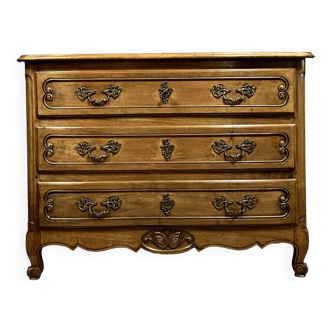 Curved Louis XV style chest of drawers in solid wood with light patina