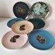 Set of 7 porcelain plates, gold foliage & jungle