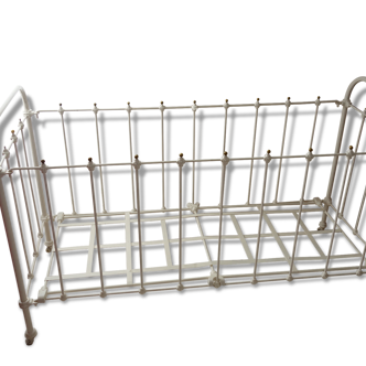 Old bed in wrought iron and brass balls