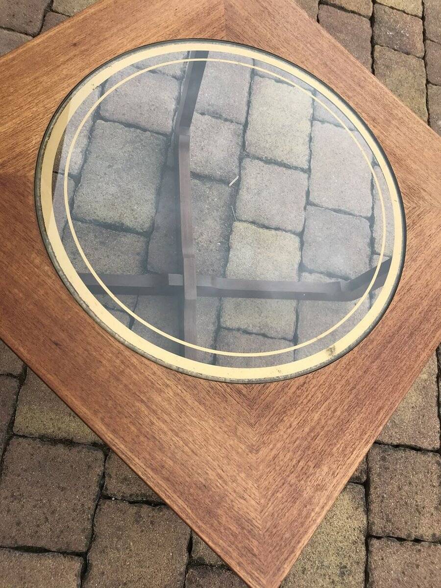 Round glass coffee table with a gold border and brown teak structure, Astro 1960s style.