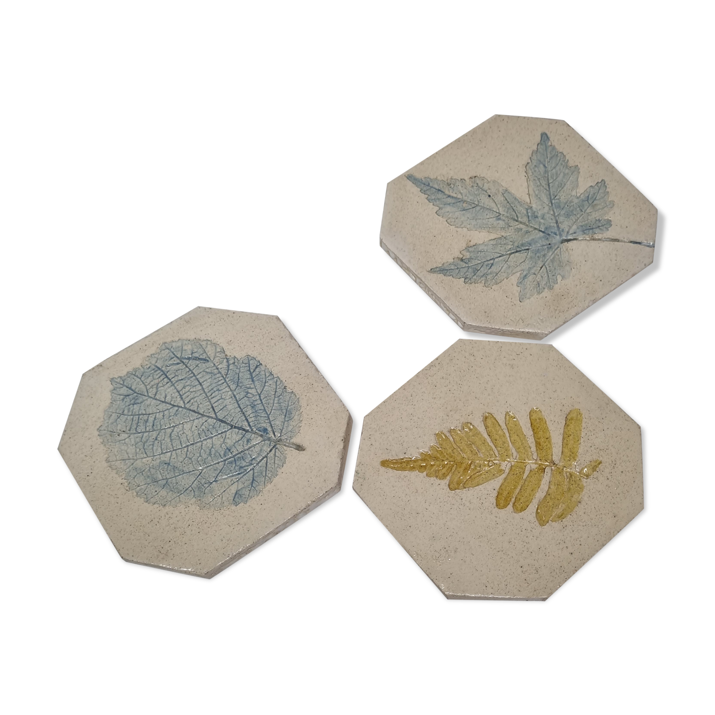 Three enamelled ceramic under glass, footprints of plants from Canada