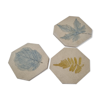 Three enamelled ceramic under glass, footprints of plants from Canada