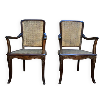 Pair of wide caned armchairs from the Art Nouveau period.