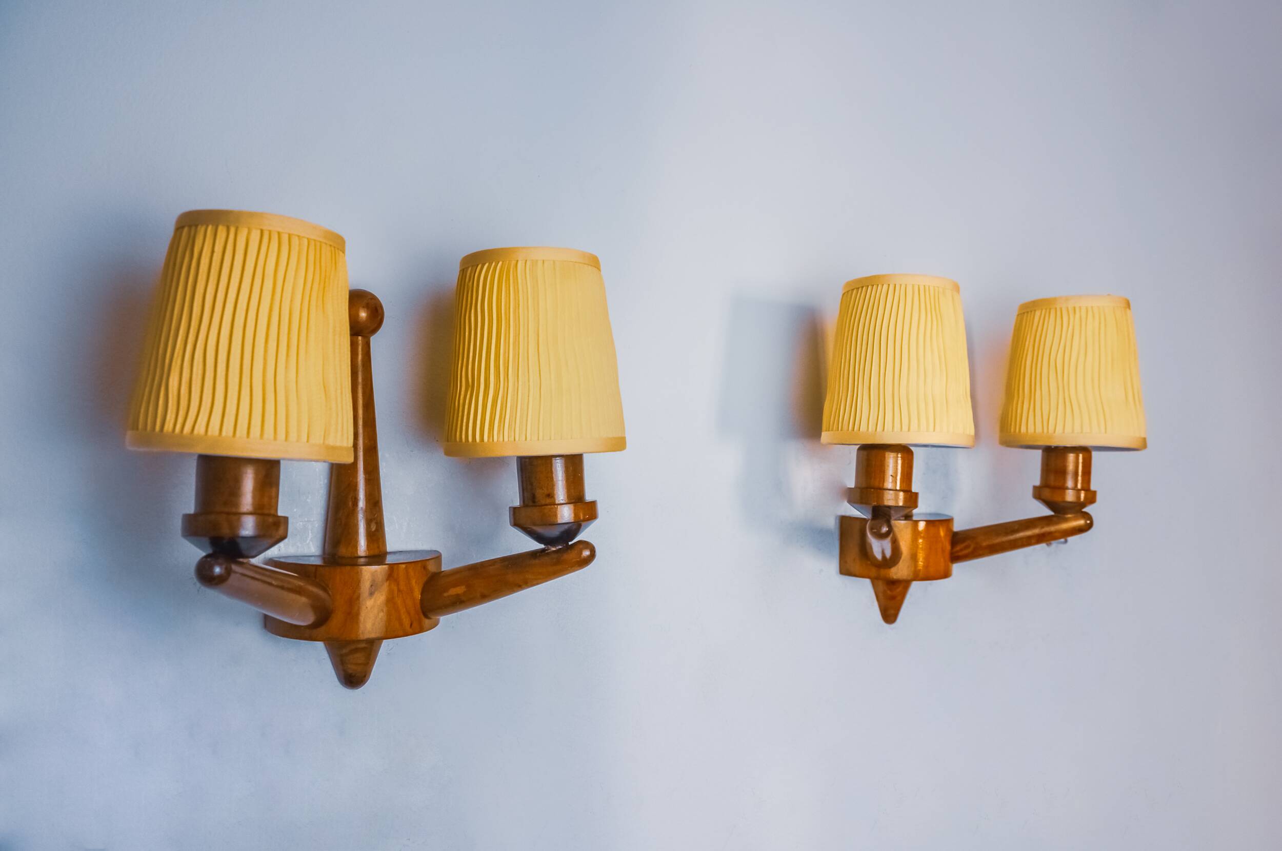 Pair of two-armed art deco "ball" wall lights, carved wood, France, 1960