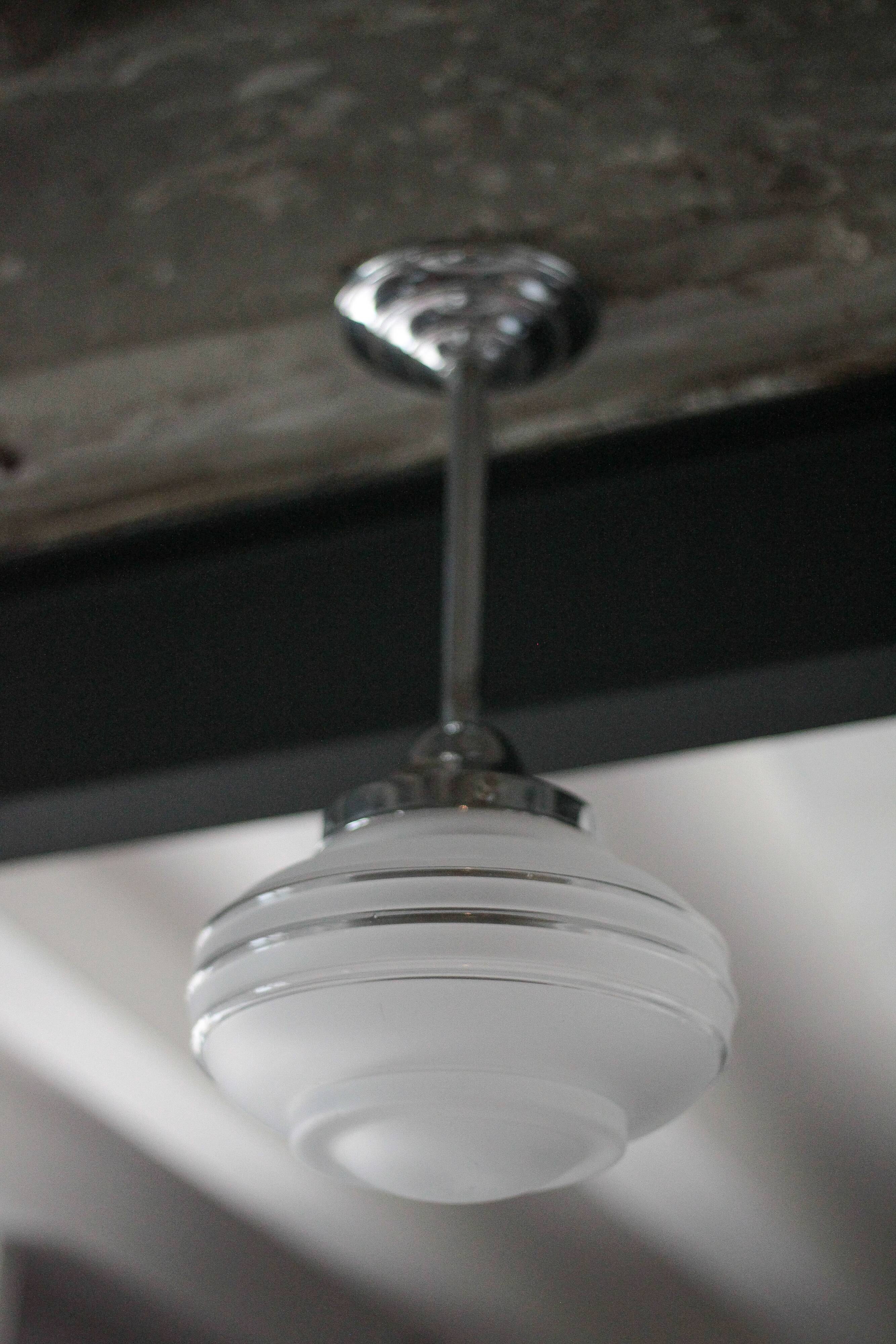 Art Deco pendant light, chrome metal suspension and glass globe, ceiling lamp.