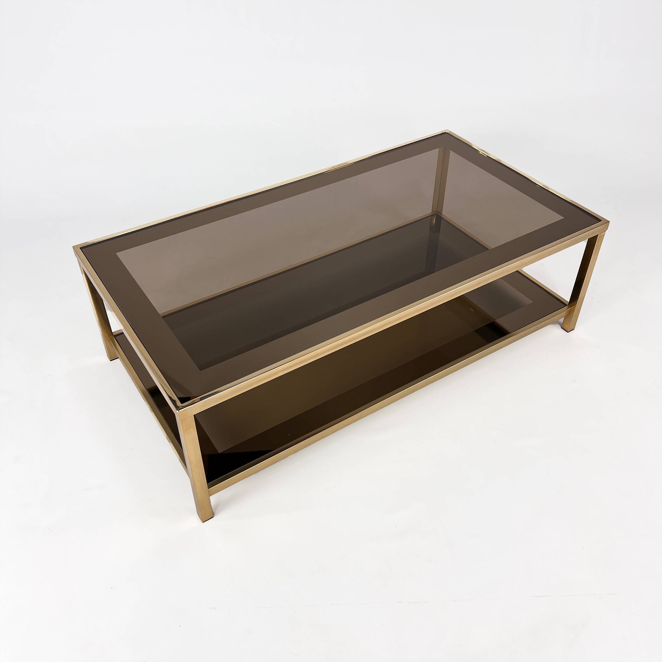 Belgo Chrome coffee table in brass and smoked mirror glass, 1970s.