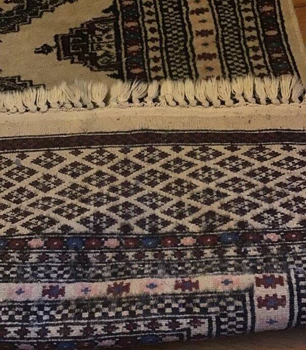 Vintage rug with oriental and geometric patterns, fringes, 63 × 90 cm