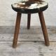 Old wooden tripod stool with seat leather vintage
