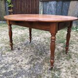 Louis Philippe oval shuttered table in solid cherry wood with 2 drawers.