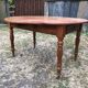 Louis Philippe oval drop-leaf table in solid cherry wood with 2 drawers.