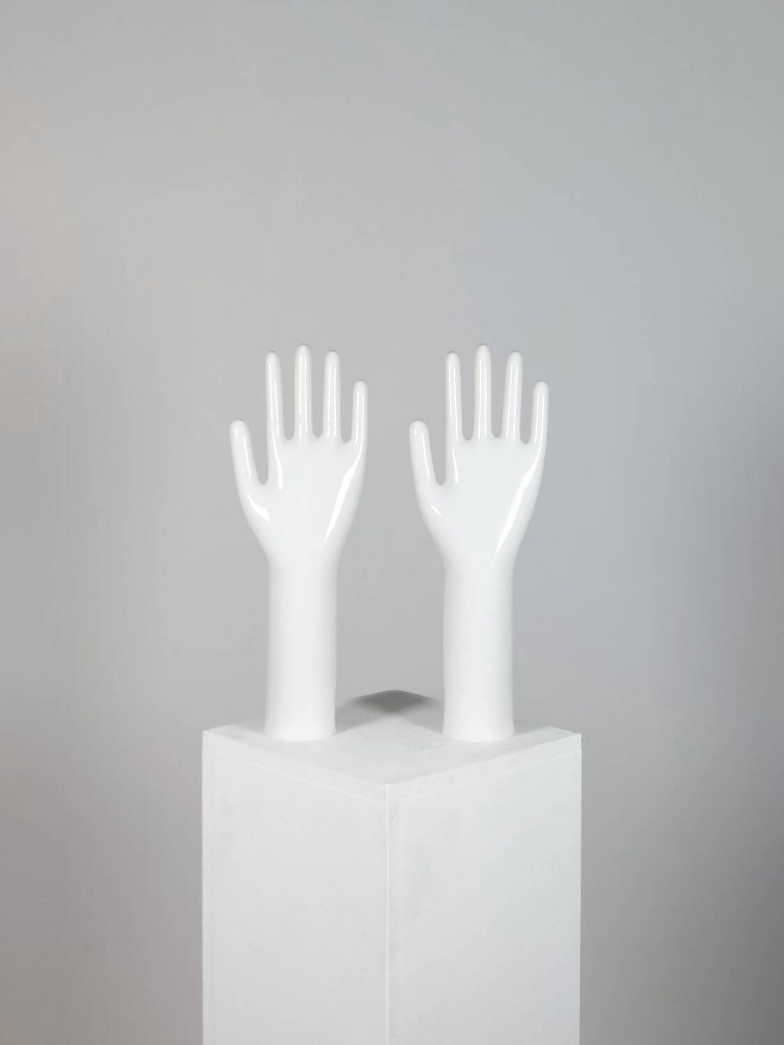 Pair of authentic vintage jewellery displays in industrial porcelain representing hands.