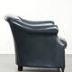 Dark blue cowhide club armchair with a unique and timeless design