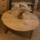 Large round antique coffee table made of raw solid wood.