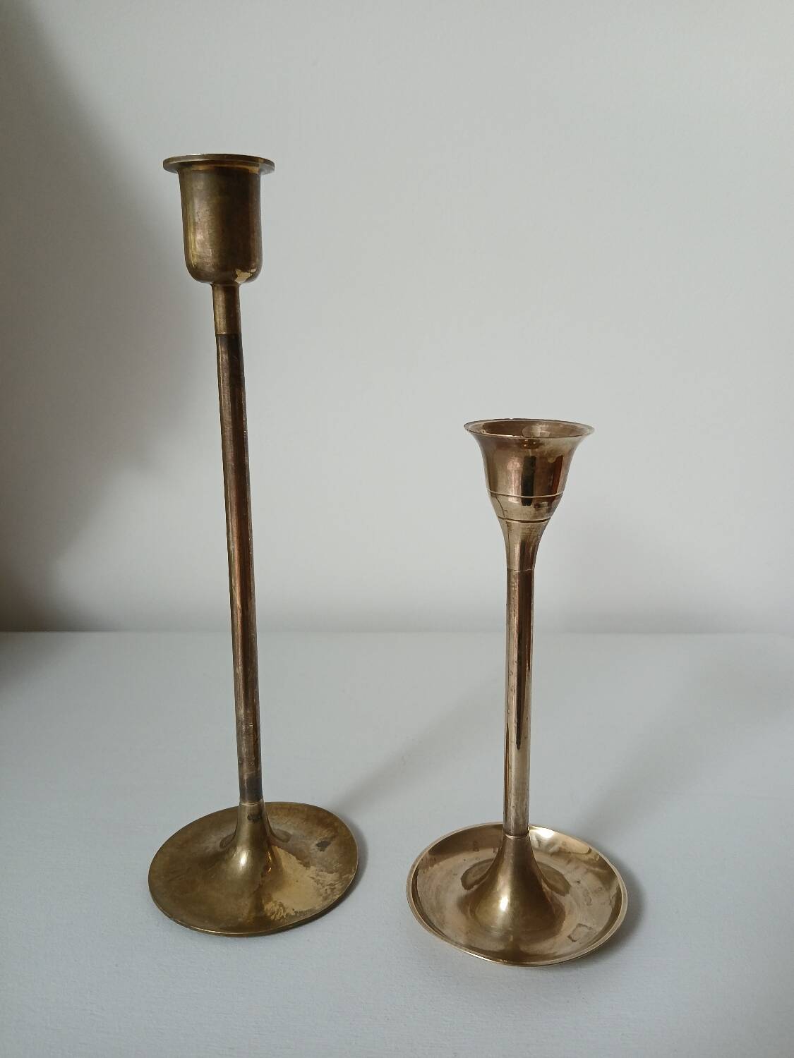 Set of two straight brass candlesticks.
