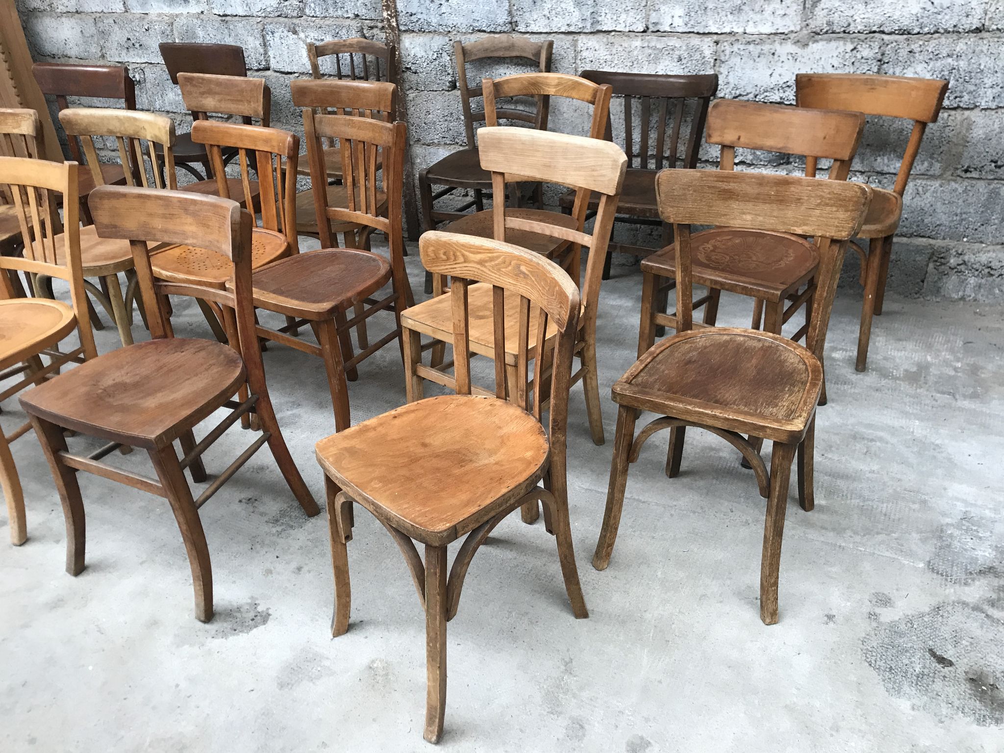 Set of 15 mismatched curved wood bistro chairs