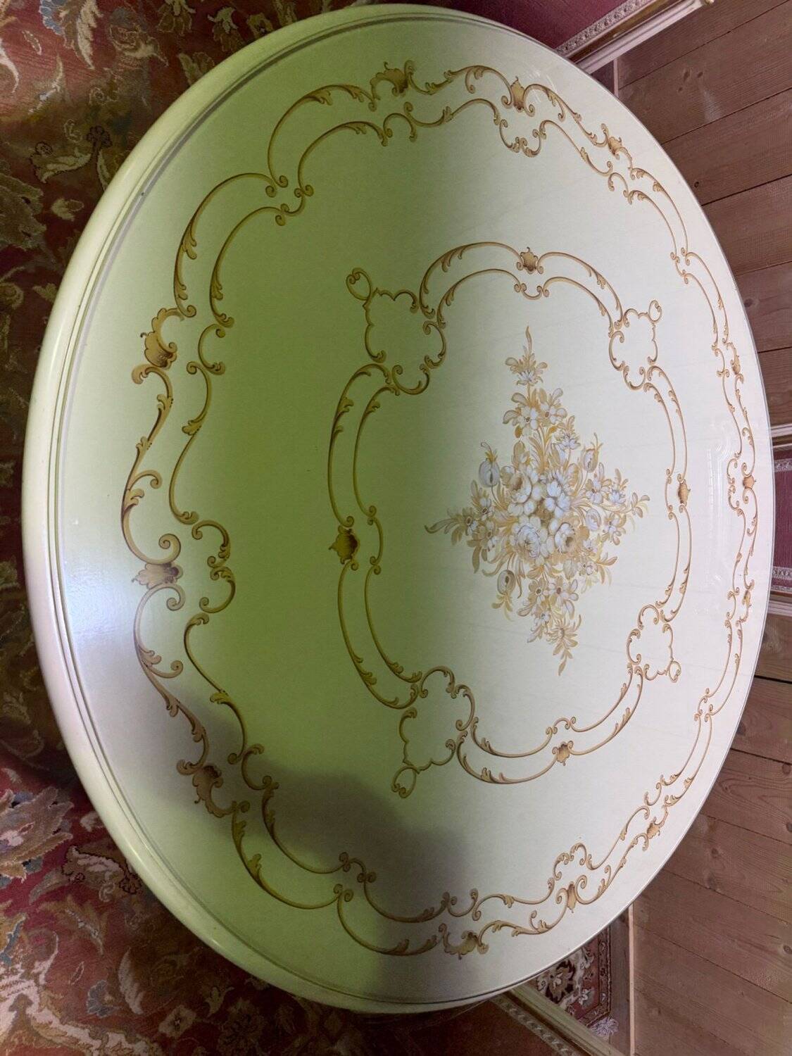Louis XVI dining room table set with painted wood, gold accents, and pink velvet.