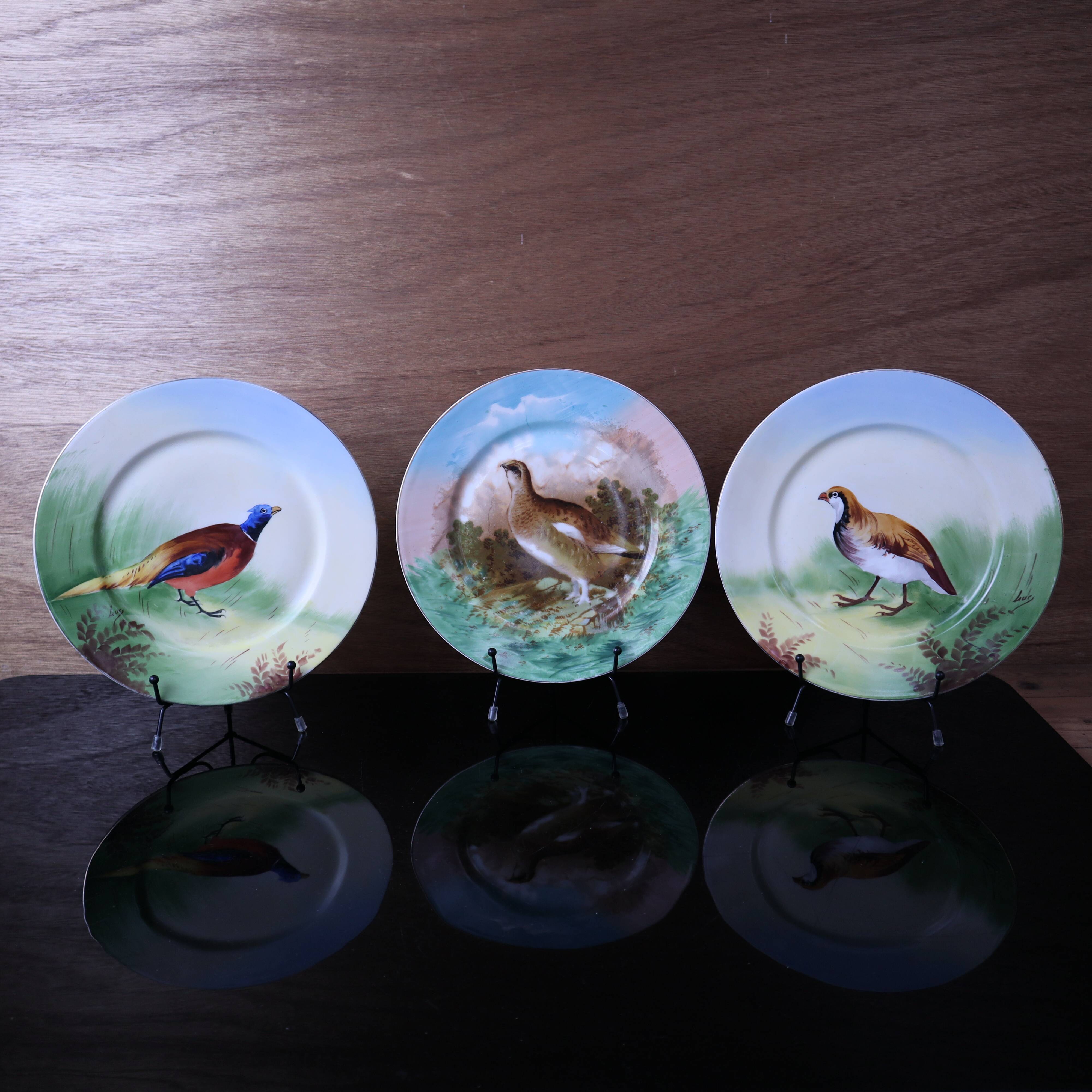 3 decorative porcelain plates from Limoges featuring partridges and pheasants.