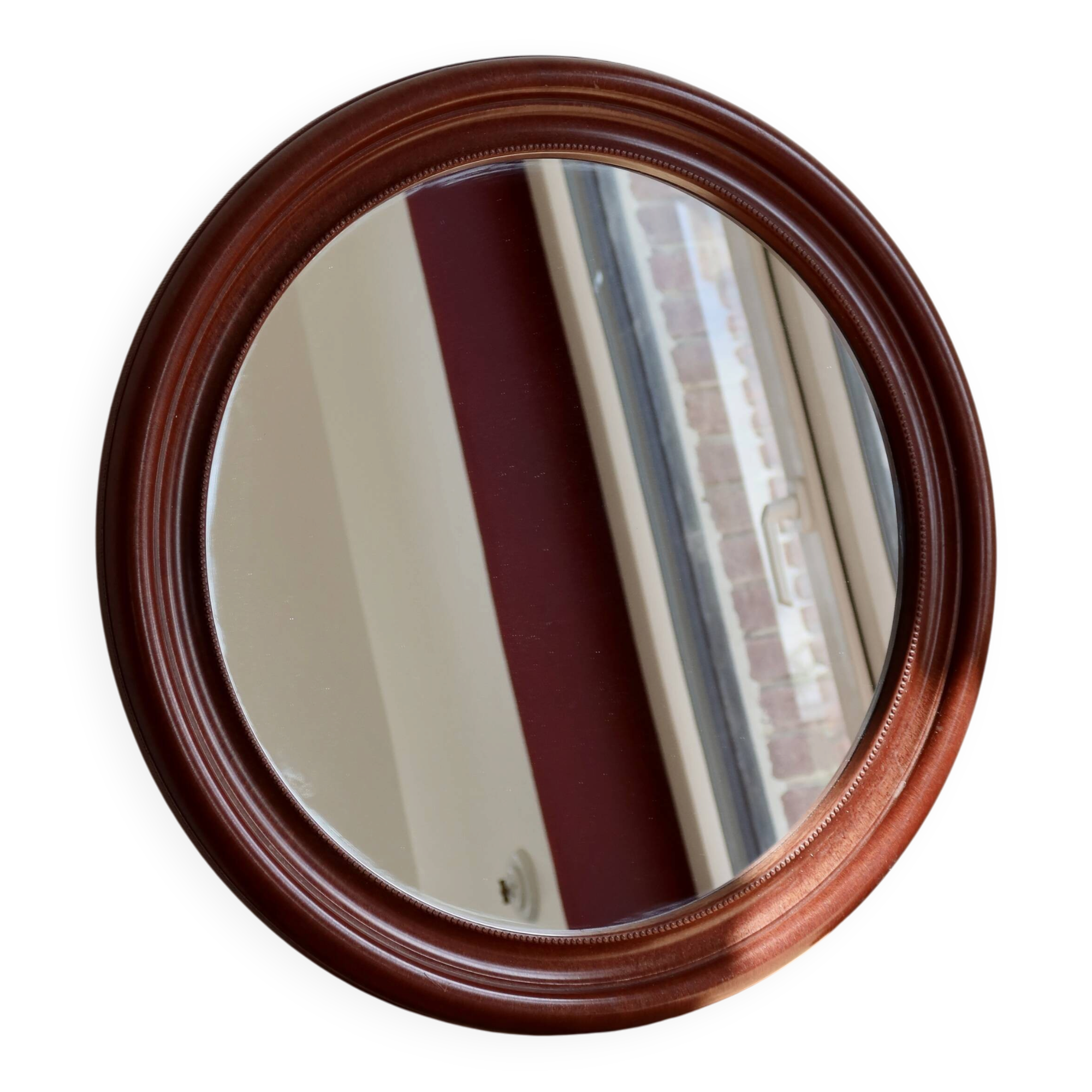 Round vintage mirror with mahogany wood effect frame.