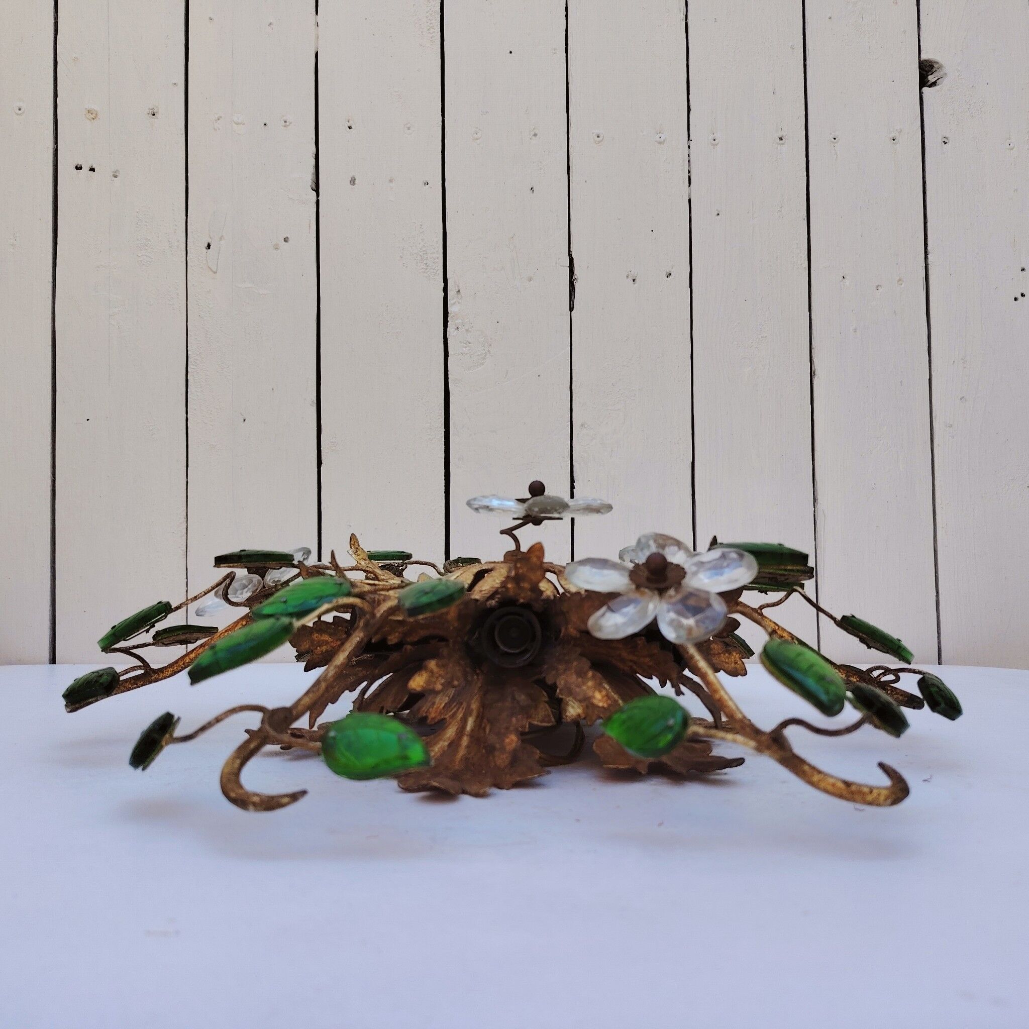 Flower wall light, gilded metal and glass cabochons, attributed to Baguès.