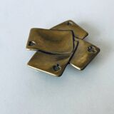 Empty pocket square of aces in brass