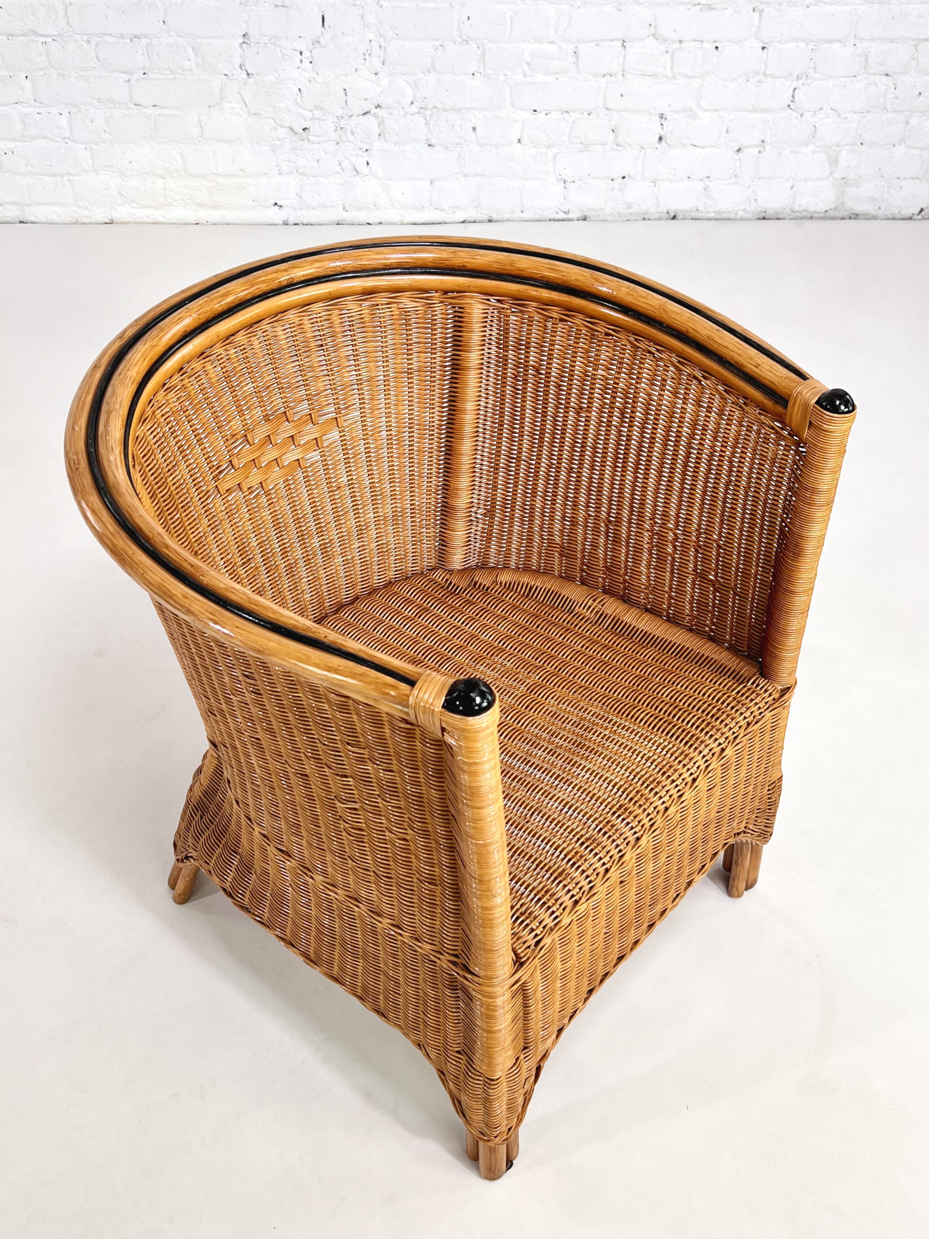 Pair of cabriolet armchairs in wicker and black edging