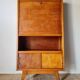 Vintage 1950s wooden secretary with tapered legs and mint interior.