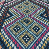 Blue carpet with multicolored patterns woven hands in natural wool