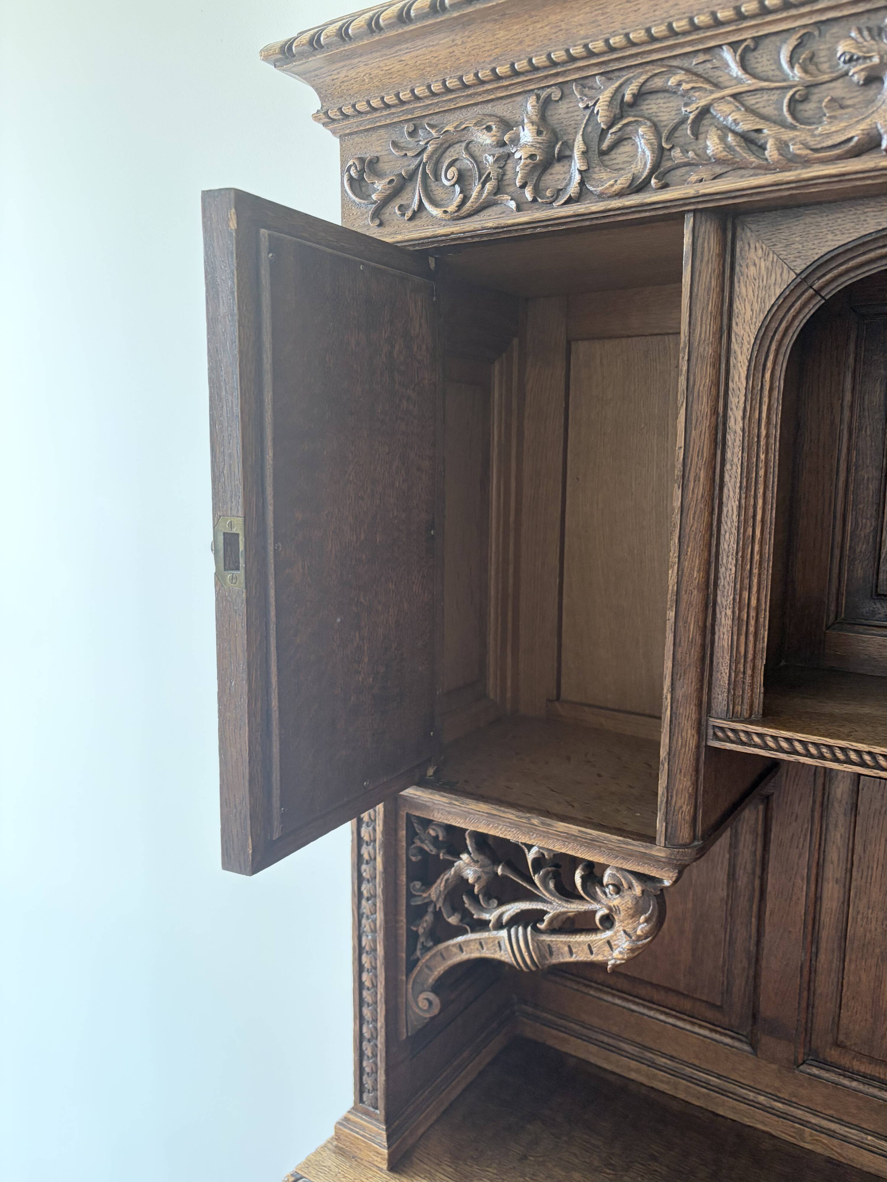 Large secretary with a drop-down front in carved oak, neo-Renaissance style.