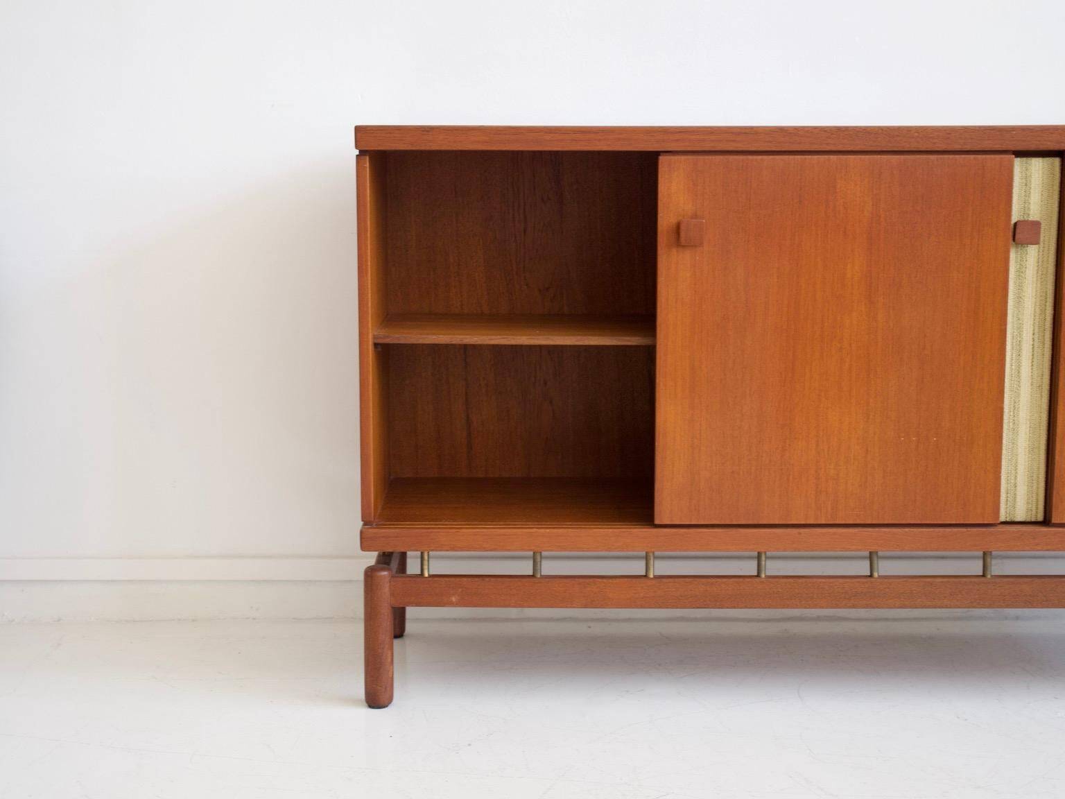 Buffet Ilmari Tapiovaara in teak with fabric and brass details.