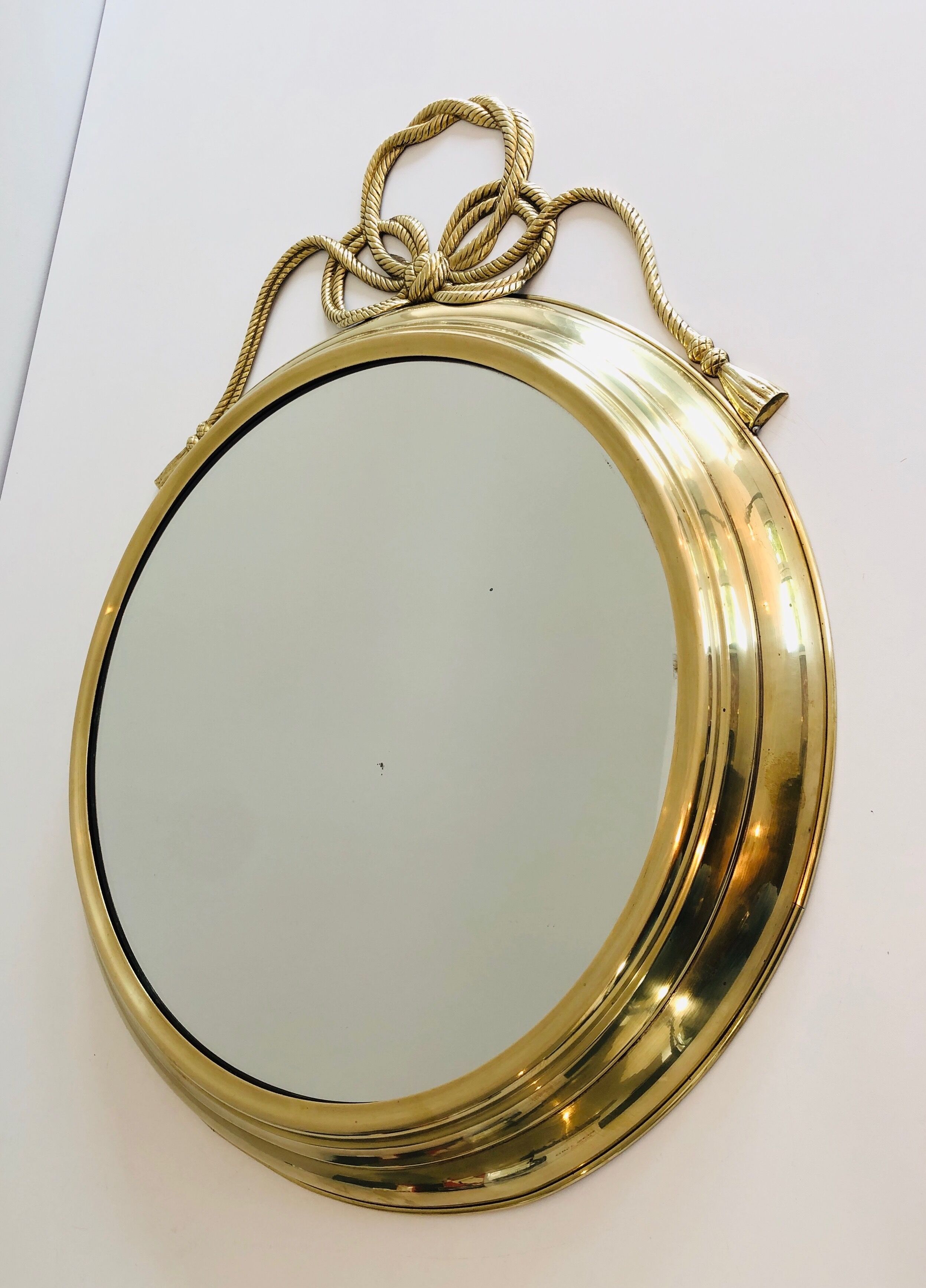 Oval Decorative Mirror in Brass decorated with an Important Twisted Knot