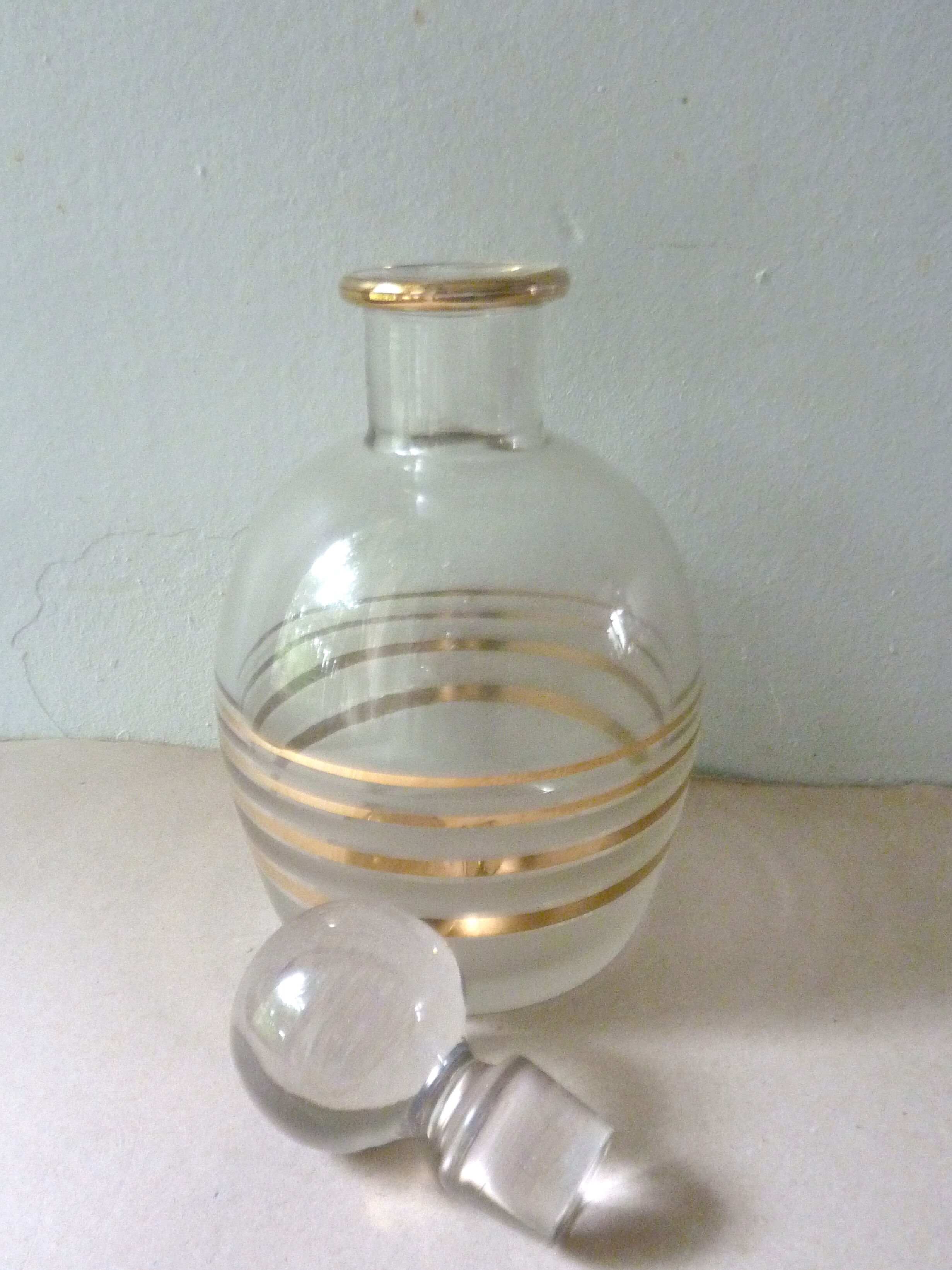 Pair of glass whiskey decanters with gold edging