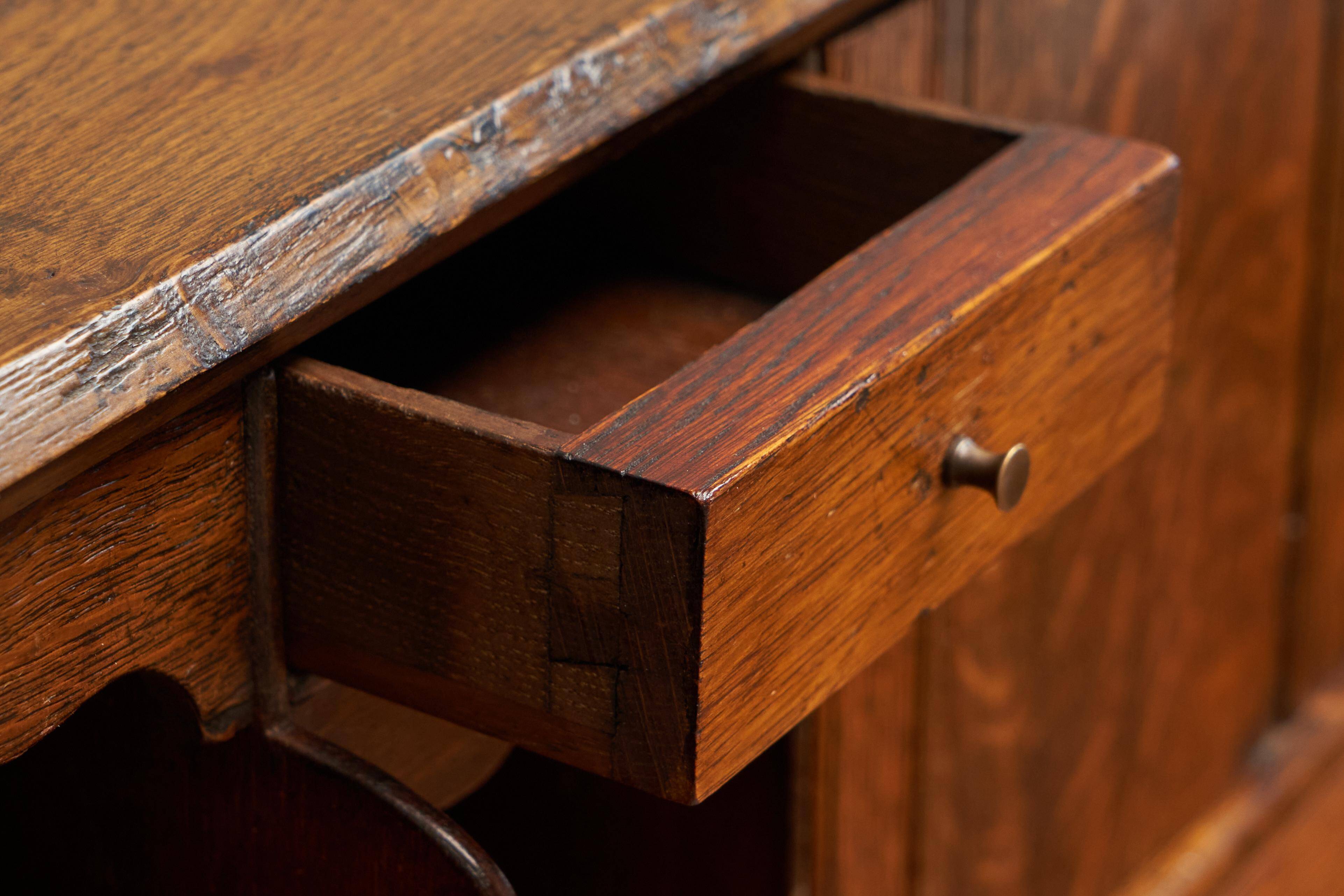 Antique English oak secretary with drop-down front.