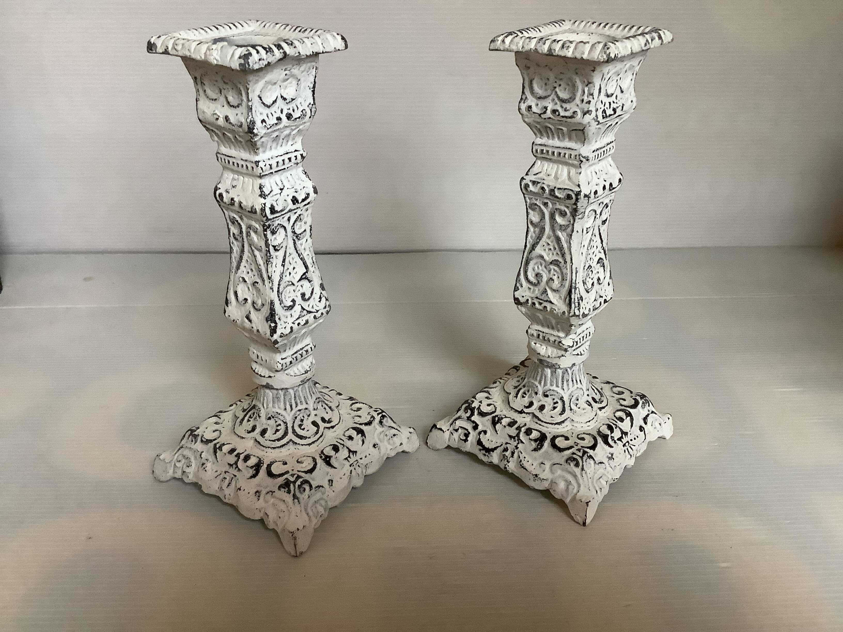 Pair of patinated cast iron candlesticks