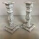 Pair of patinated cast iron candlesticks