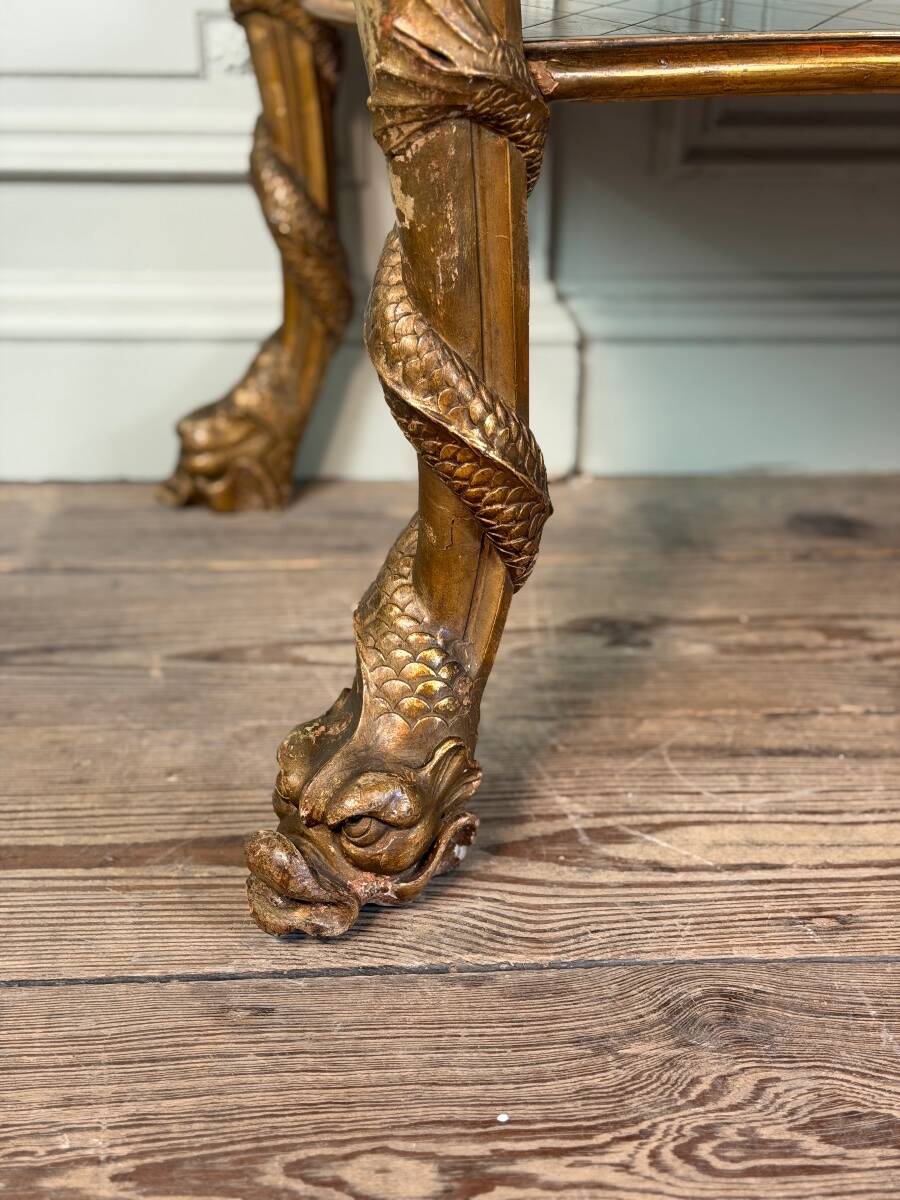 Golden wooden console, four legs adorned with sea monsters, purple breccia marble, around 1900.