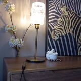 Table lamp with gold metal base and cylindrical textured glass shade