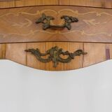 Baroque style wooden chest of drawers with bronze frieze.