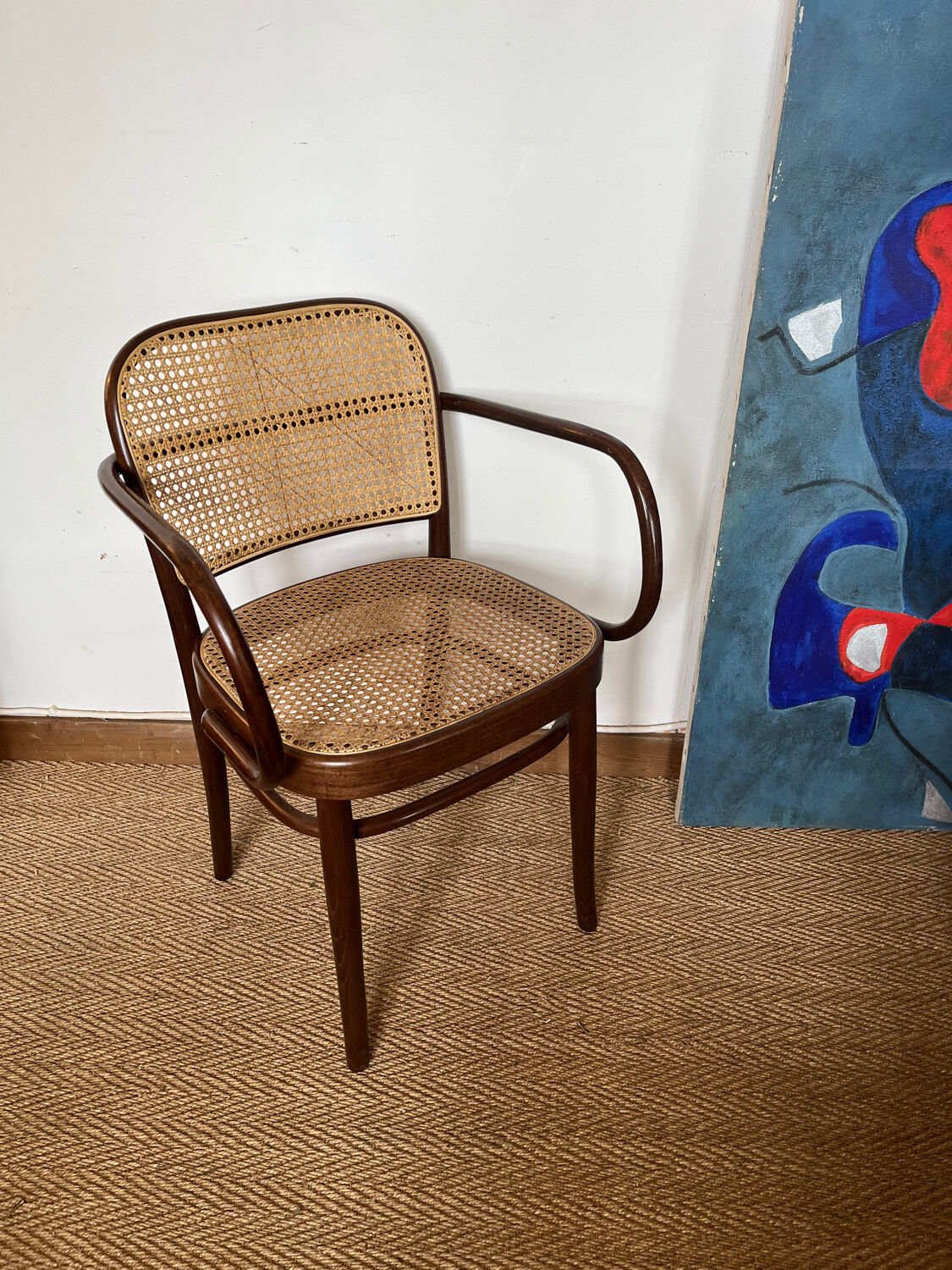 Curved wood and cane armchair