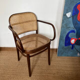 Curved wood and cane armchair