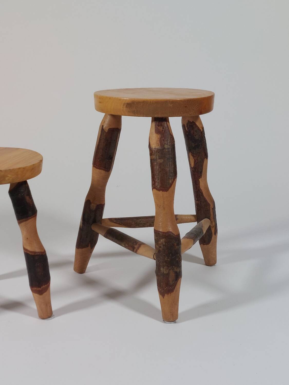 Pair of walnut stools sculpted in a vintage mid-century cross-section.