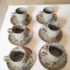 Series of stoneware cups and saucers