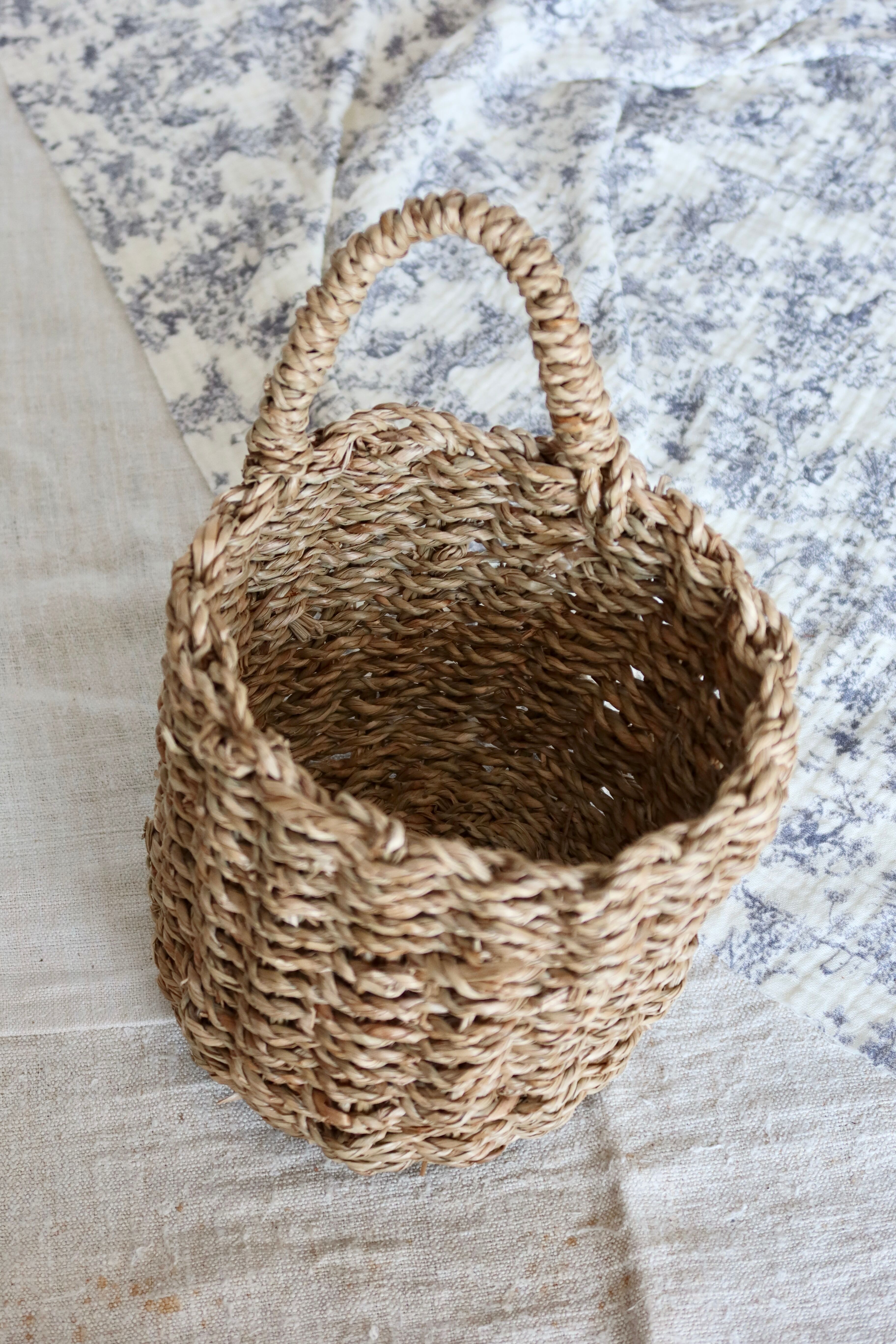 Small vintage woven fiber wall basket with handle