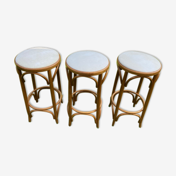 3 bar stools made of curved wood and fabric seat