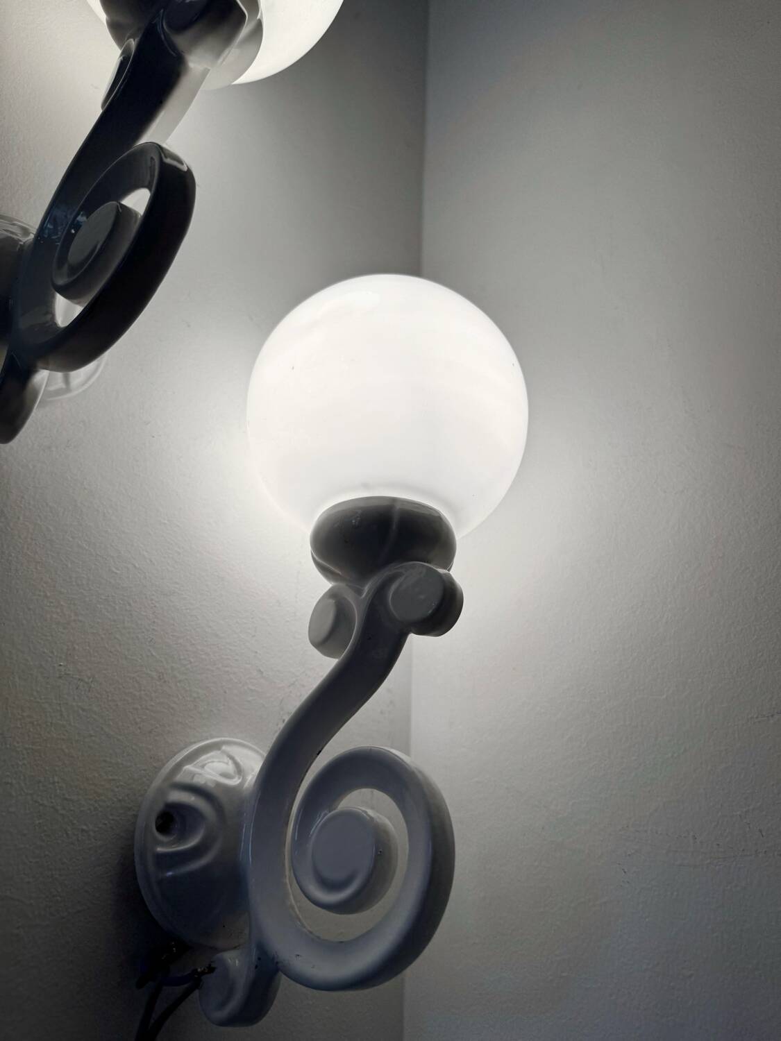 Cast iron and opaline wall lights from the 70s