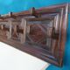 Wall-mounted coat rack in solid oak with 9 hooks.