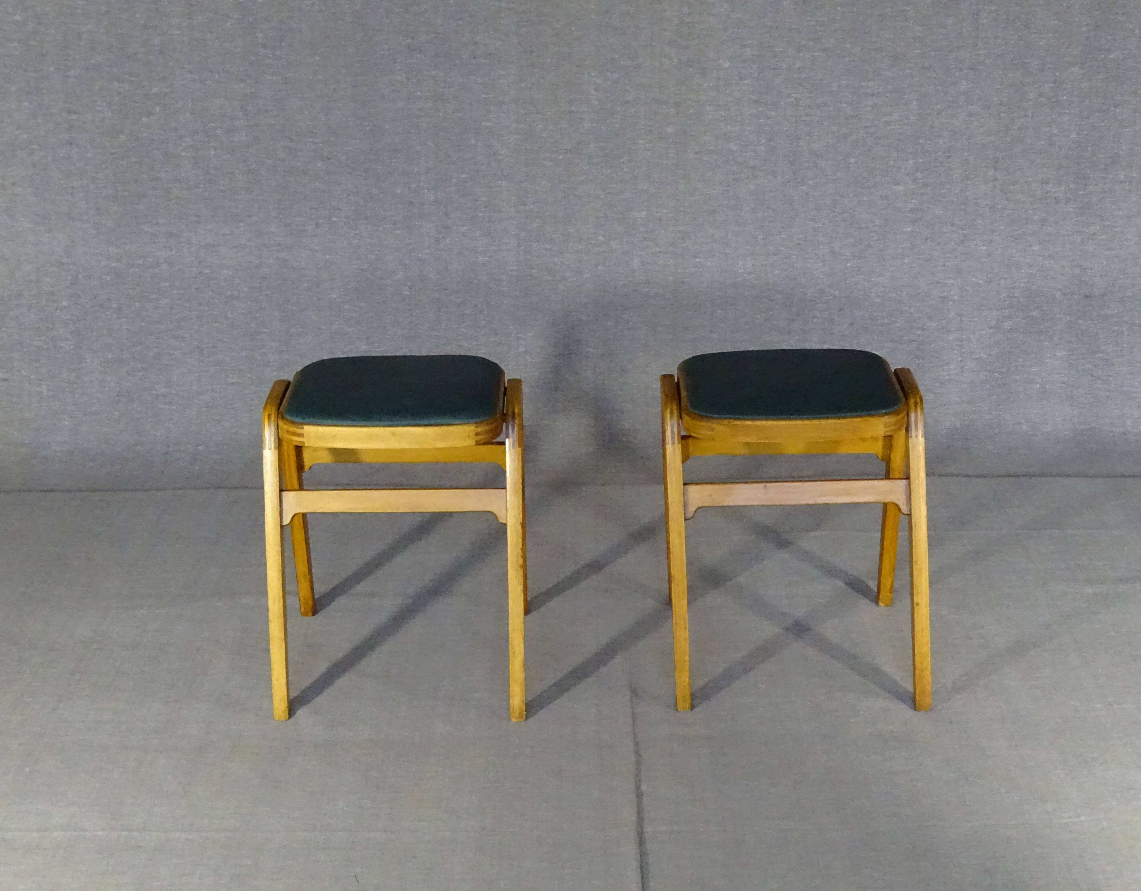 Two MID-Century green vinyl stools from the 1970s with tapered legs.