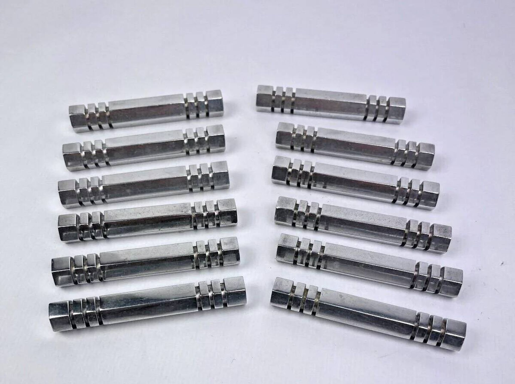 Set of 12 chrome metal knife rests by Louis Prodhon, Art Deco.