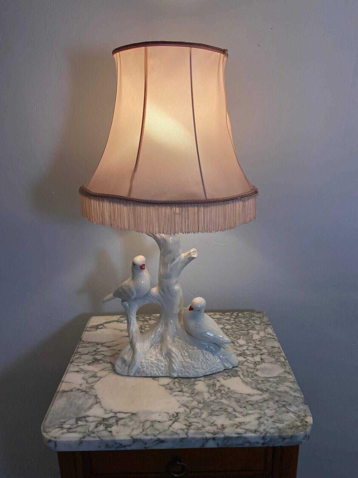 Ceramic lamp with birds, pink fringed shade, 1950s.