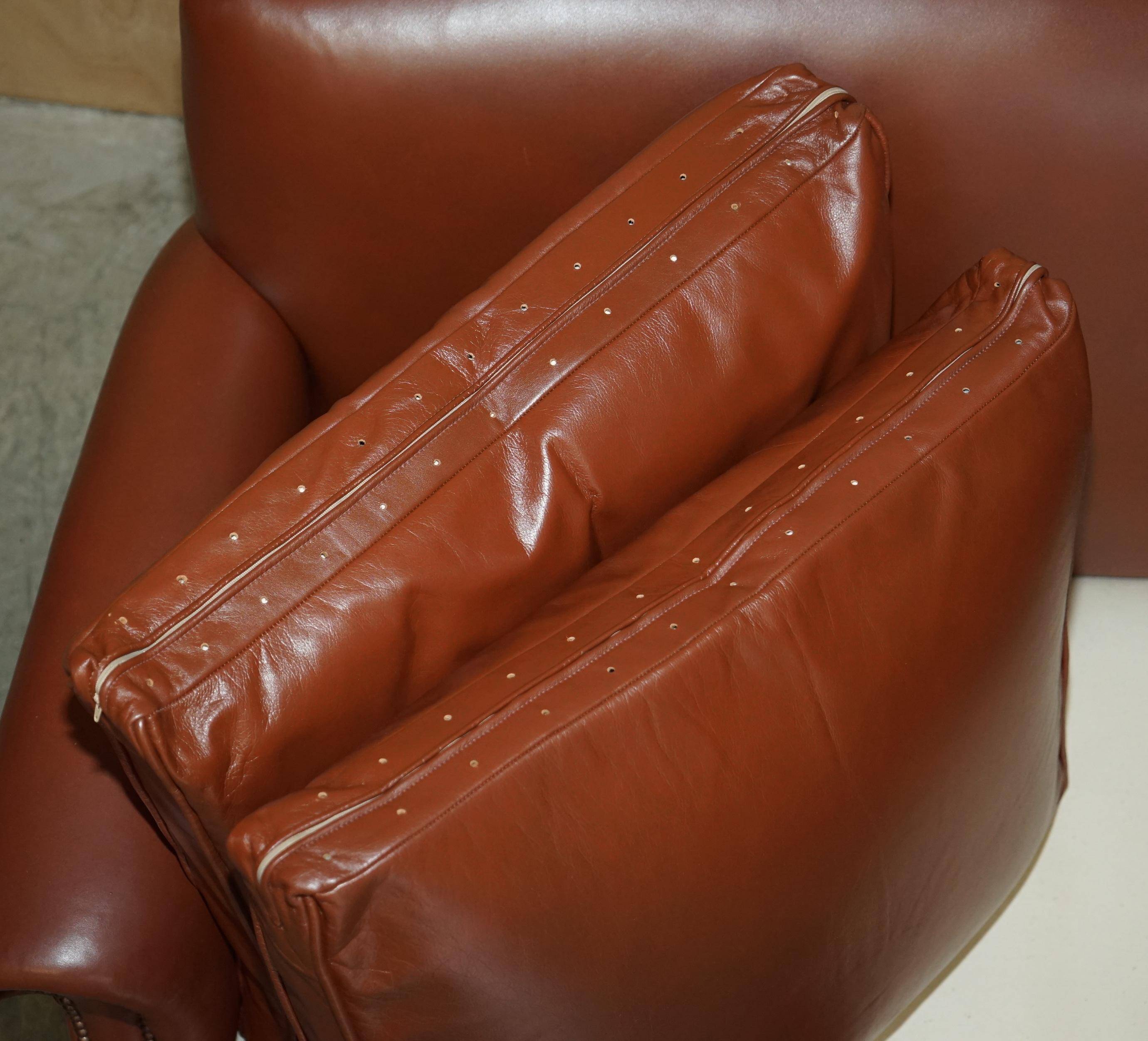 Edwardian leather club canapé circa 1910 with feather cushions.